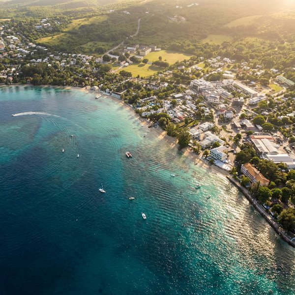 A breathtaking drone shot of Holetown Beach, Barbados, showcasing turquoise waters and golden sand.